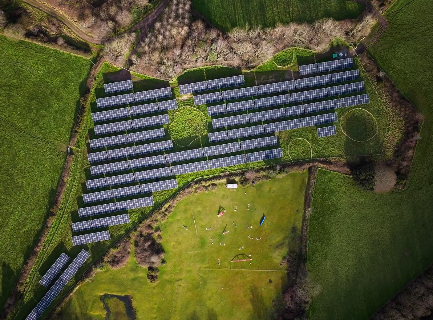 Rodda's 1,680 solar panels mounted in a green field, a ring of fencing in the top left marking a mine shaft